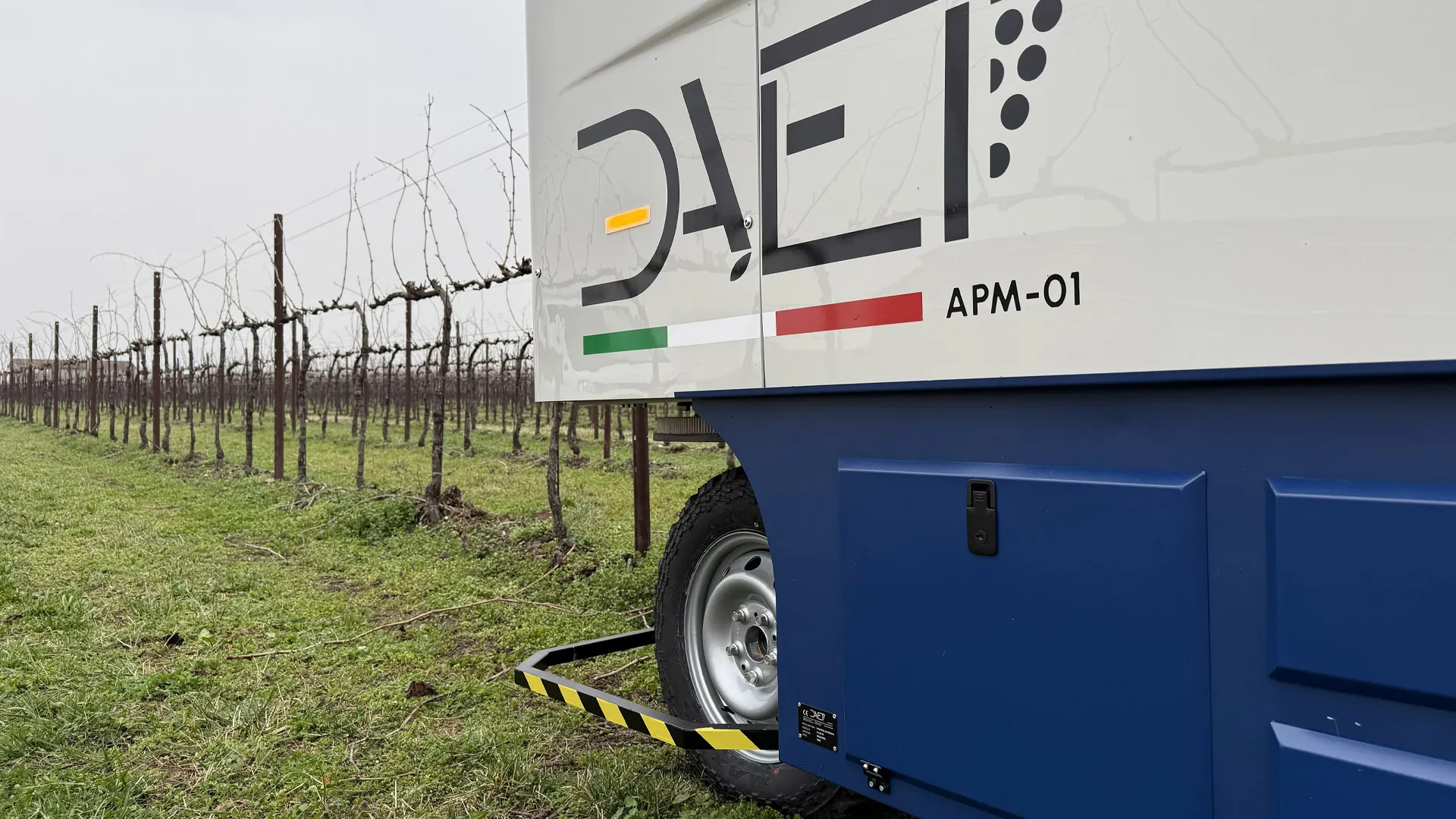DAET logo and APM-01 lettering on the autonomous winter vine pruning machine